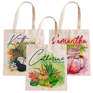 Three tote bags with personalized names and tropical designs on a white background